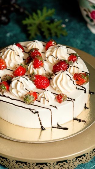 classic cake decorated with chocolate sprinkles and strawberries